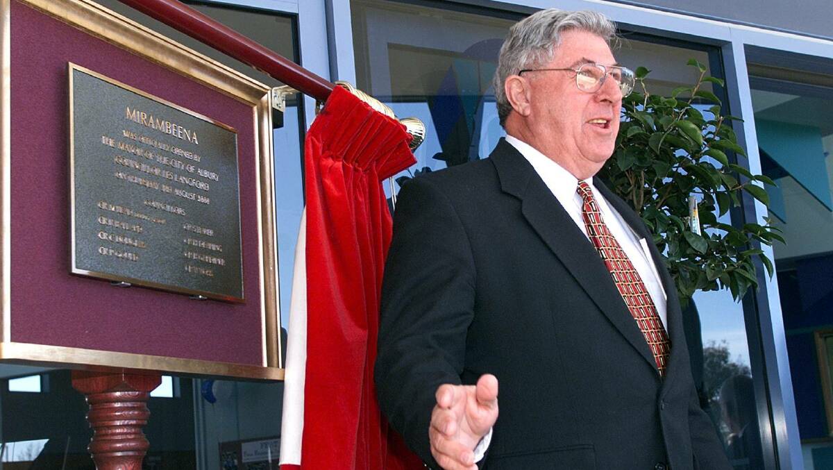 Red curtain day: Les Langford officially opens Lavington's Mirambeena community centre in August 2000.