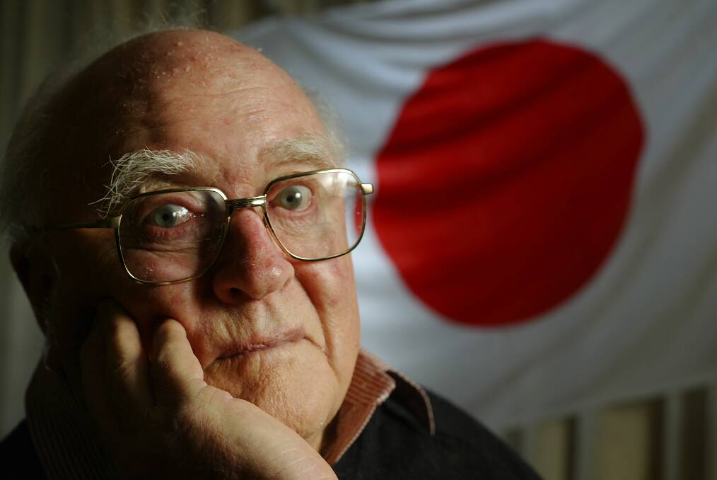 Diverse life: Roy Guthrie pictured in 2008 with a Japanese flag for a Border Mail story about his memories of the Cowra Breakout of 1944.