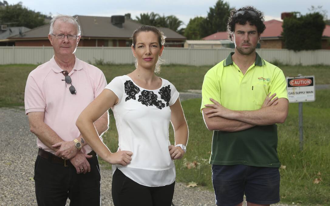 Not happy: Noel Bennett, Bec Harris and Chris Daly on the block of land earmarked for four units. Picture: ELENOR TEDENBORG