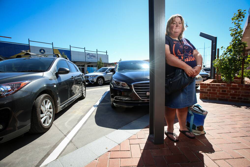 Concern: Shopper Tracey Cook fears cars may hit poles due to smooth paving rather than gutters near parking bays.