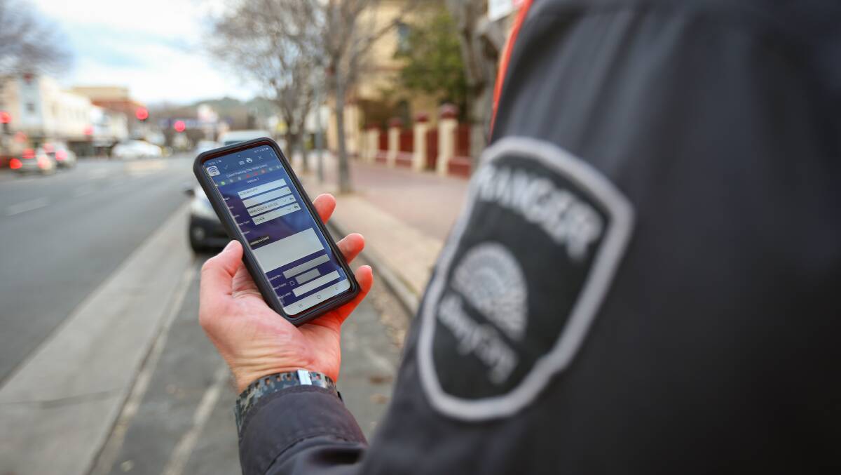 Fingertip detail: An Albury Council ranger shows off the app which he will be using to monitor car parking occupancy in the CBD as part of a digital switchover. Picture: JAMES WILTSHIRE