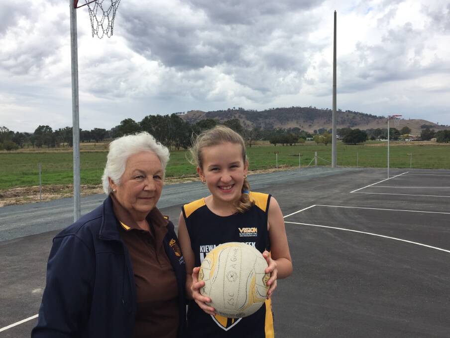 Pride on show: Kiewa-Sandy Creek Netball Club president Di Kerr and grand-daughter Isabella Whitsed, 10 who plays midgets on the new netball courts.