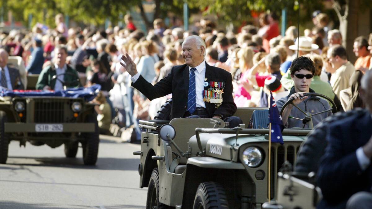 Story told: Late World War II returned soldier Ken Tonkins waves to onlookers during Albury's Anzac Day parade in 2005.