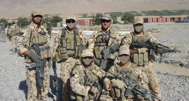 Mates: Corporal Baird (far left) and Eddie Robertson (back, second from right) with fellow commandos in 2007. Corporal Baird earned a Medal for Gallantry on that stint.