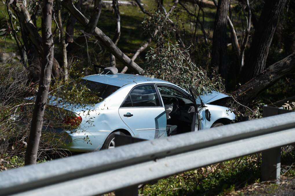 Tragic sight: The car which crashed into a tree alongside the Beechworth-Wangaratta Road on Tuesday resulting in the death of a man in his 80s. Picture: MARK JESSER