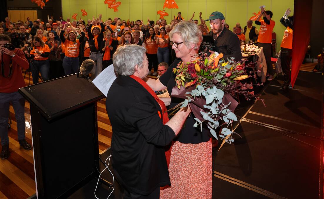 Adoring crowd: Helen Haines receives a bouquet as her supporters cheer her following a victory speech at the Wangaratta Performing Arts Centre on Saturday night. Picture: JAMES WILTSHIRE