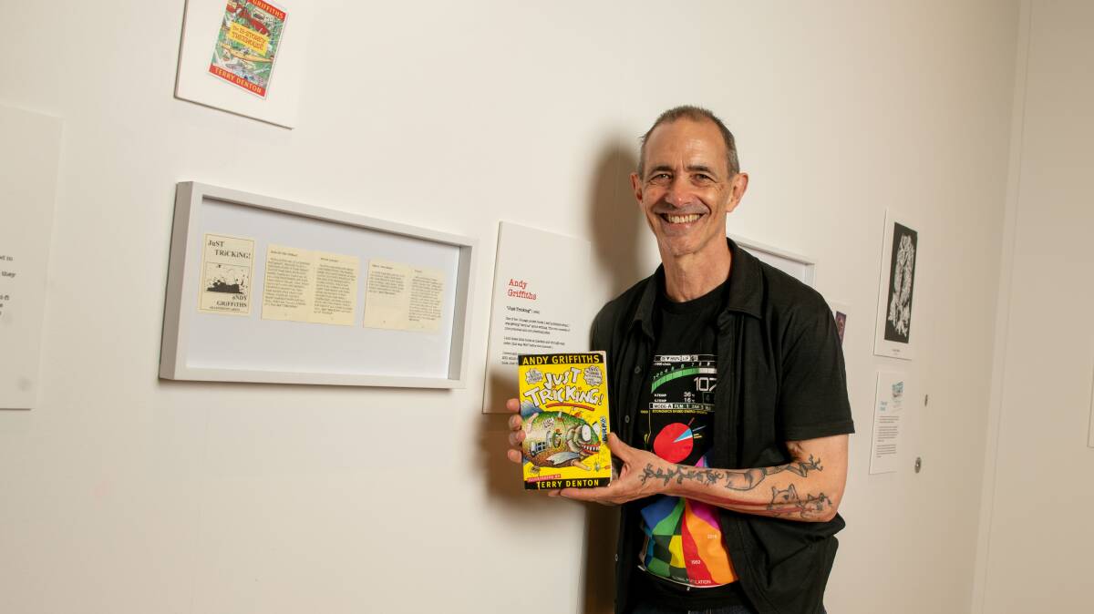 Andy Griffiths next to some tiny pages which he made up in the 1990s and eventually resulted in his Just! series of books, one of which he is holding. Picture by Tara Trewhella