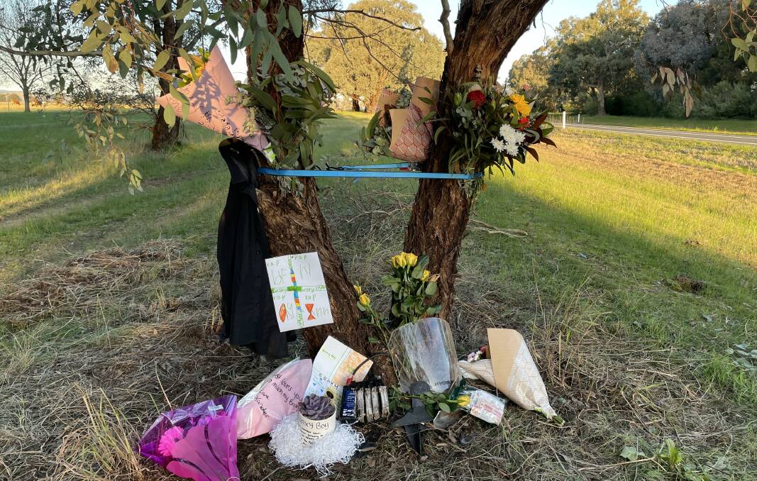 Paying tribute: Bouquets festoon a tree alongside the Riverina Highway after the death of Albury man Braxton Hurt on Saturday afternoon. 