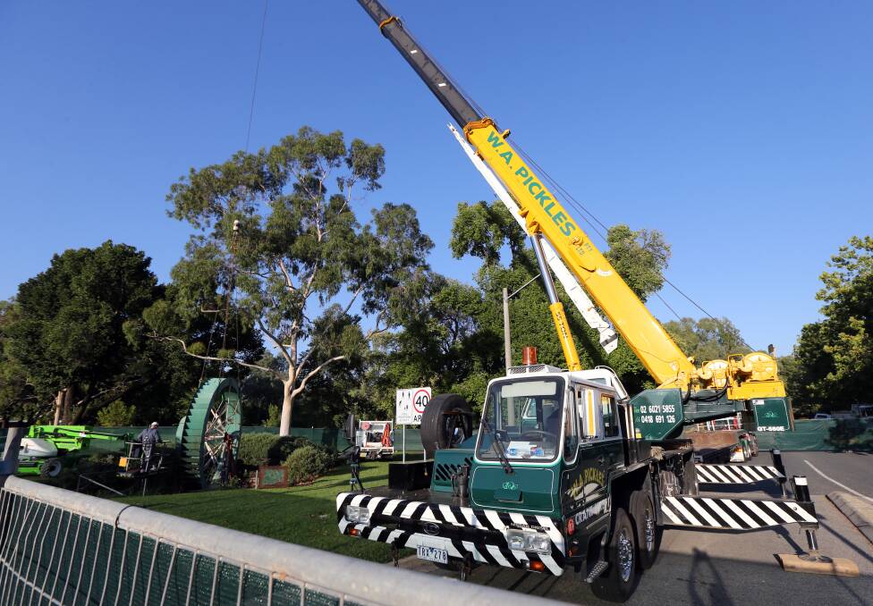 Pulled out: A crane takes the water wheel from its position in Australia Park in February 2014.