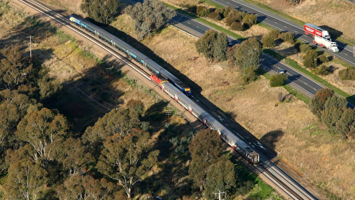 Hot and cold: Hot and cold: XPT and V/Line trains pass west of Wodonga, on a track section where tea and coffee is served on the NSW service but not on the Victorian one.