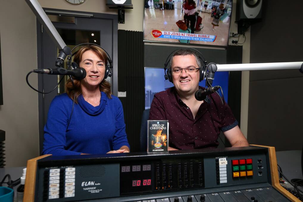 Milestone: Broadcasters Kylie King and Kev Poulton with a decades-old cassette tape Spirit of Christmas, recorded with 2AY support, that has been unearthed as part of 90th anniversary celebrations. Picture: JAMES WILTSHIRE