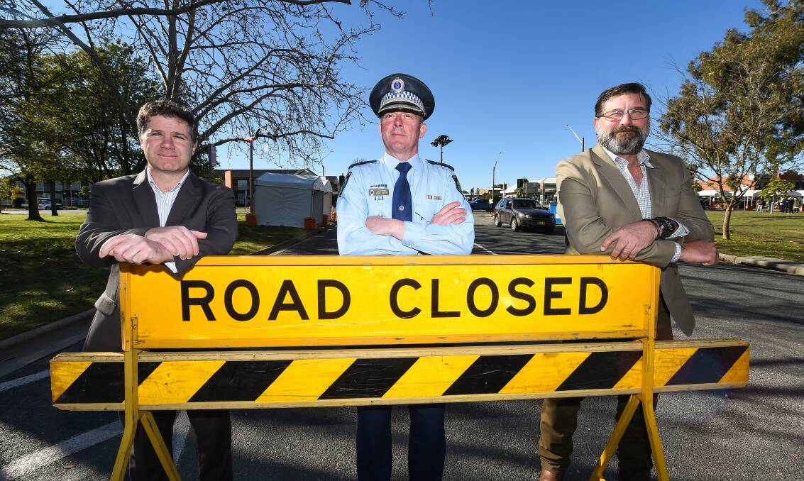 United front: Member for Albury Justin Clancy, Murray River police district chief Superintendent Paul Smith and member for Benambra Bill Tilley near the Wodonga Place border checkpoint on Friday. Picture: MARK JESSER