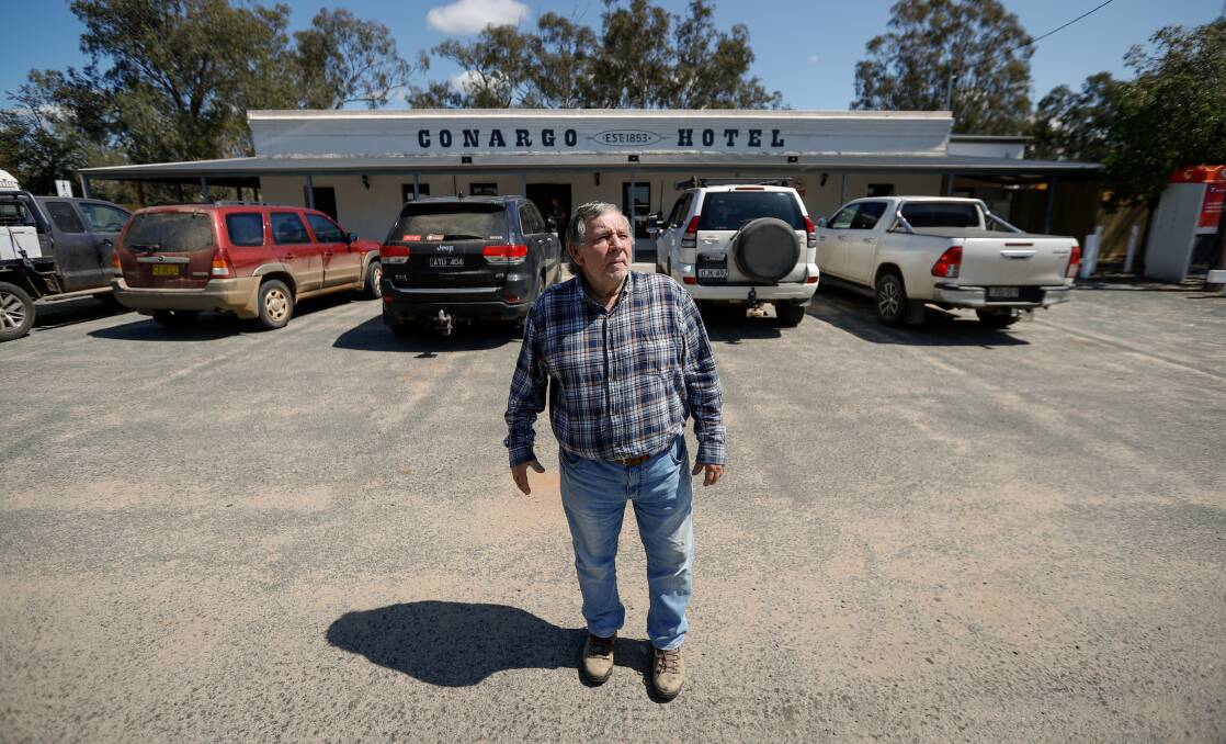 Pub owner Michael Lodge outside the Conargo Hotel which had its car park filled with cars as the watering hole opened after nearly eight years since a ruinous fire. Picture by James Wiltshire