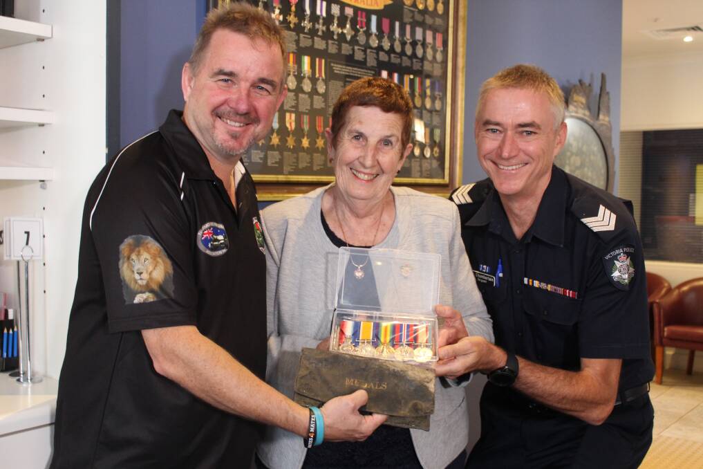 Puzzle: Peter Duncombe, Robyn Chambeyron and Anthony Chamberlain with the medals. Mr Duncombe paid for their repair and handed them to Mrs Chambeyron at the Wangaratta RSL on Sunday. Picture: WANGARATTA CHRONICLE