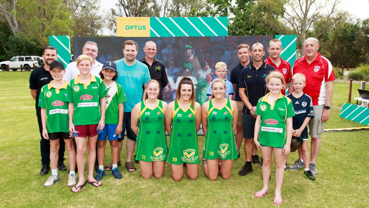 Screen dreams realised: Representatives of Optus, North Albury junior football and netball sides and Wodonga Diamonds gather in front of the type of screen which will be installed at Bunton Park and La Trobe University soccer ground. Picture: SIMON BAYLISS