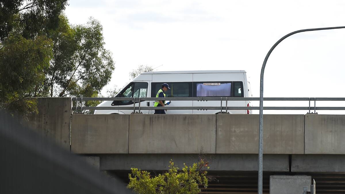 Inspection: A police officer scrutinises the Ford Transit van at the centre of Sunday's incident which saw a man die on the Hume Highway in Albury. Picture: MARK JESSER