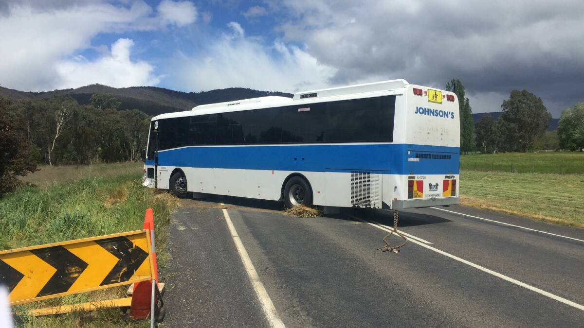 Back on solid ground: The school bus on the Beechworth-Wodonga Road after being pulled from the verge where it came to rest on Wednesday afternoon.