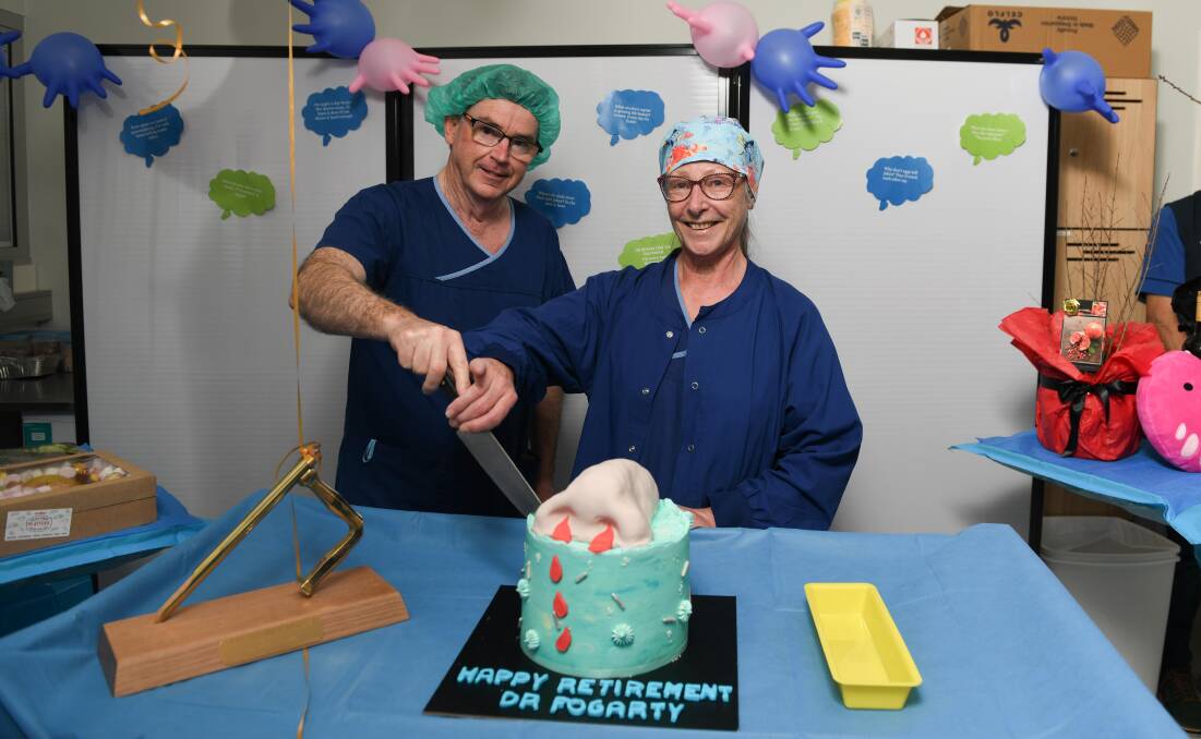 Dr Fogarty is assisted by his specialist nurse Virginia Mitchell in cutting the cake to mark his departure from working at Albury Wodonga Health. Picture by Tara Trewhella