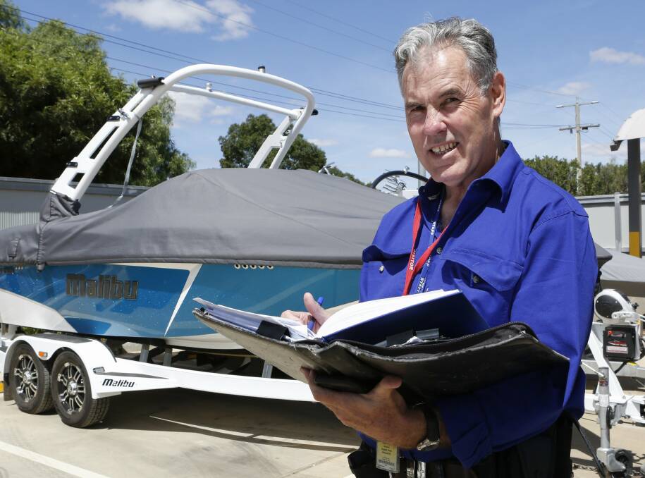 Recovered: Cobram detective Marcus Boyd with the wakeboat owned by Supercars driver Mark Winterbottom that was found at Echuca after being stolen from Cobram. Picture: RIVERINE HERALD
