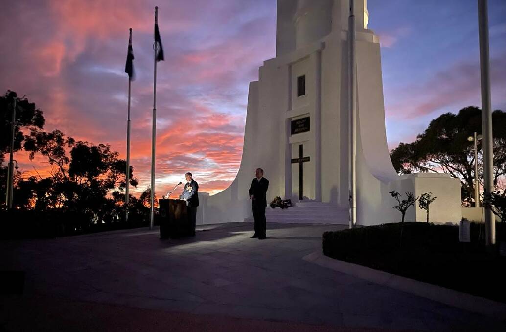 Solemn occasion: Albury RSL sub-branch president Graham Docksey addresses the dawn service on Monument Hill as the event's host Nigel Horne watches on.