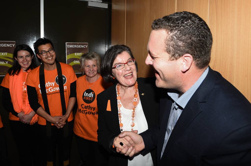 Tale of two candidates: Member for Indi Cathy McGowan shakes the hand of National Party rival Marty Corboy on election night in July. Newly released figures show the independent spend ten times what Mr Corboy spent on print advertising.