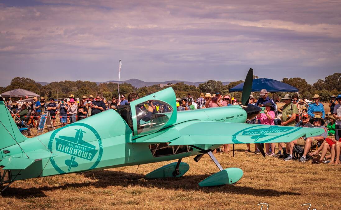 Spectators who braved the sweltering weather on Saturday admire one of the planes that featured at Benalla's airshow. Picture by Duncan Fenn Photography