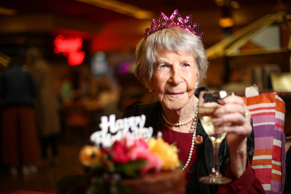 Here's cheers: Hazel Fox marks her 105th birthday with white wine and a chocolate ganache cake at a party with 50 family and friends Albury's Commercial Club on Sunday. Picture: JAMES WILTSHIRE