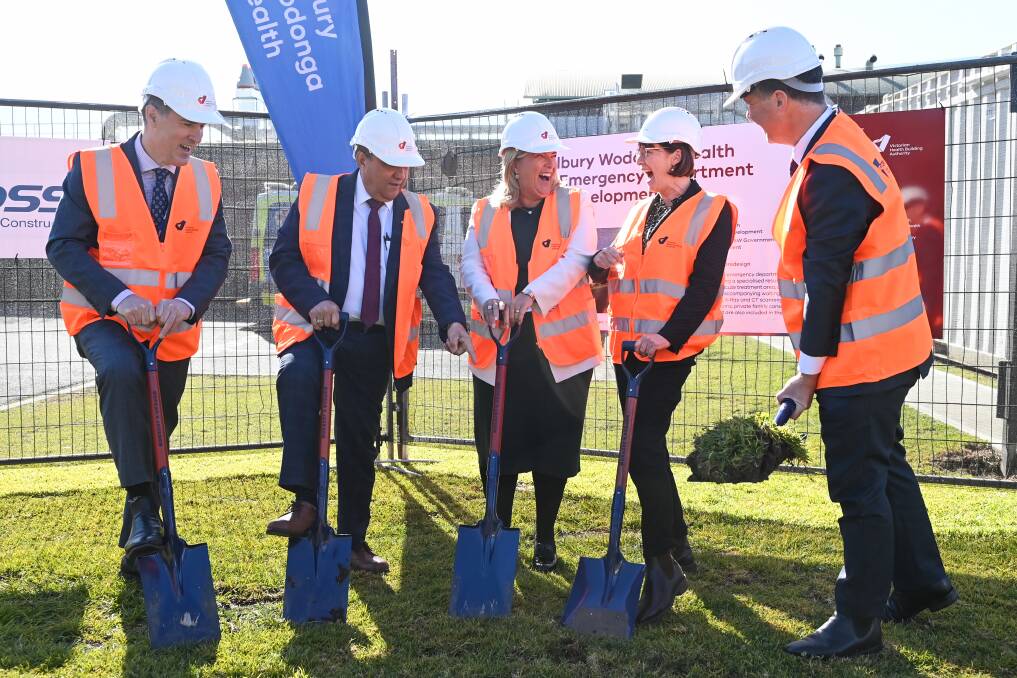 Moment of levity: Health ministers Bronnie Taylor (centre) and Mary-Anne Thomas (next right) share a laugh as a ceremonial sod was turned for the upgraded emergency department at Albury hospital. Watching on were (from left) Albury Wodonga Health's chief executive Bill Appleby and chairman Matt Burke and Albury MP Justin Clancy. Picture: MARK JESSER, 