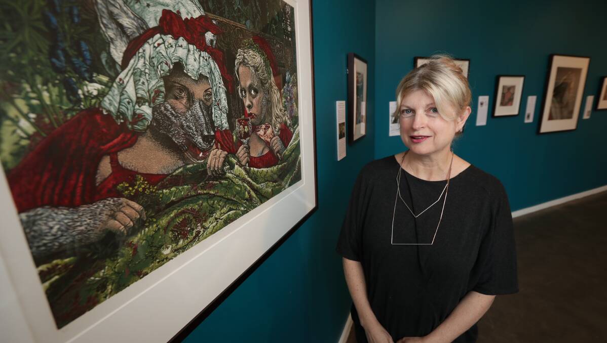 Twisted tale: Gallery director Bryony Nainby with Jazmina Cininas' linocuts reflecting on Little Red Riding Hood. Picture: JAMES WILTSHIRE 