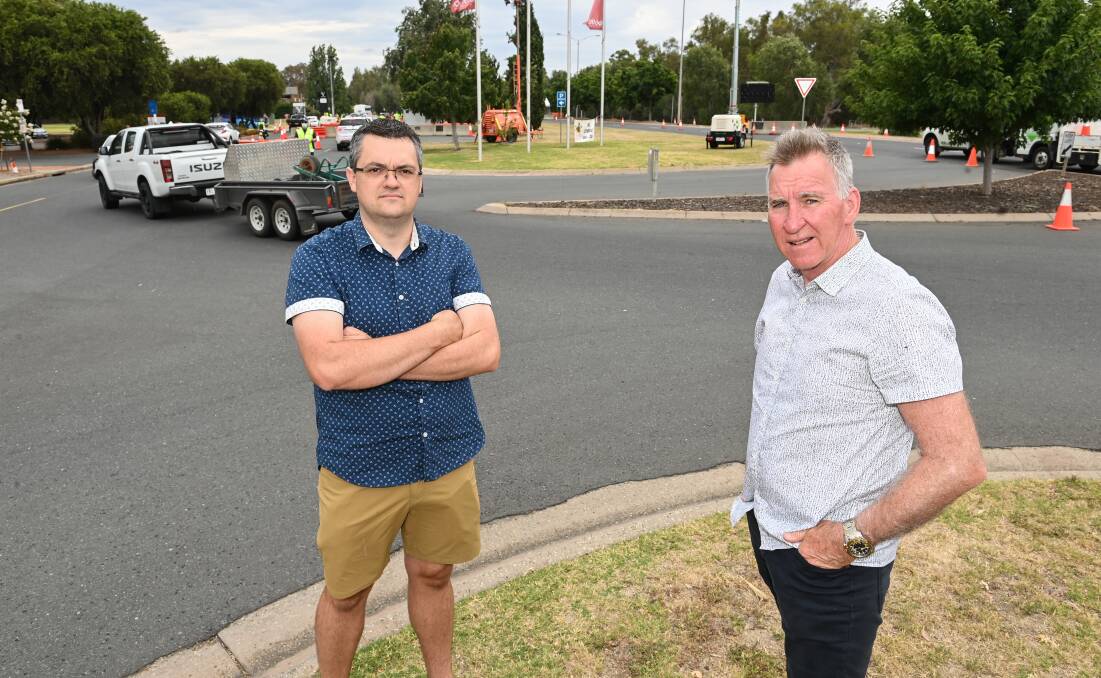 Left isolated: Wodonga mayor Kev Poulton and his Albury counterpart Kevin Mack at the Lincoln Causeway border checkpoint on Friday. Picture: MARK JESSER