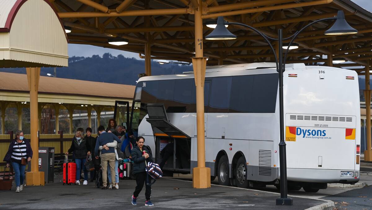 Still to be a familiar site: A bus replacement service for a V/Line train drops passengers off at Albury station recently. Picture: MARK JESSER