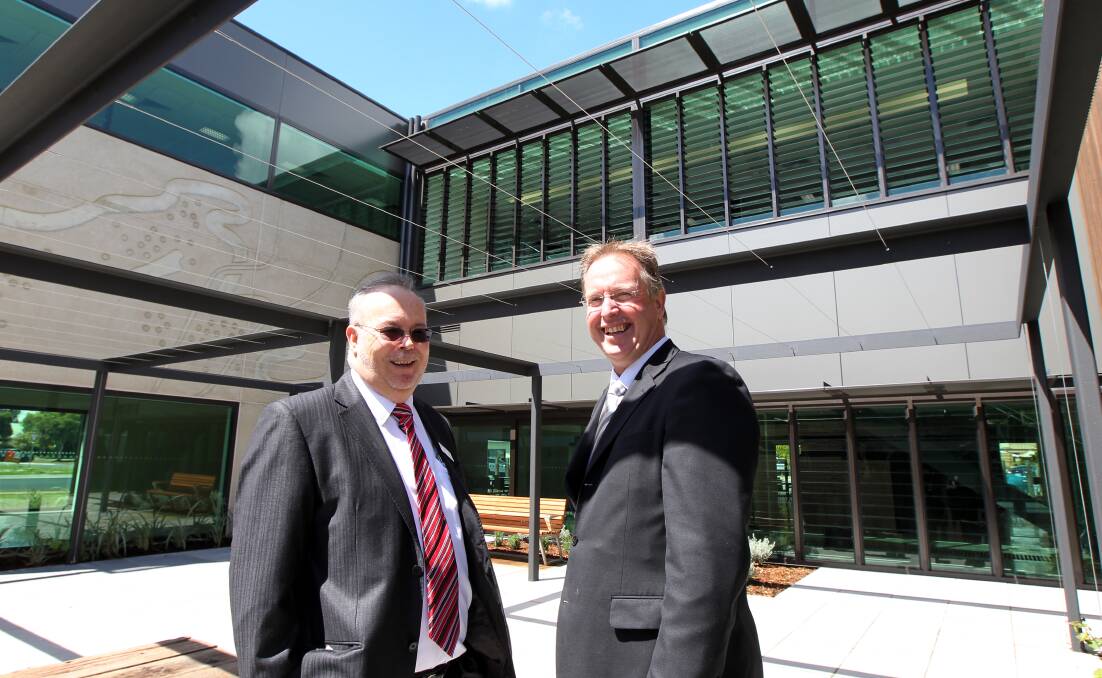 Flashback: Then Wodonga TAFE chief executive Michael Michael O'Loughlin and Wodonga mayor Mark Byatt in the courtyard of the building when it opened in 2010.