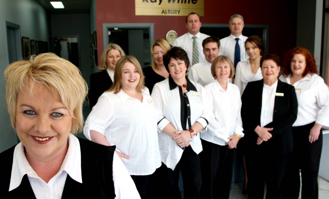 Proud leader: Sharon Jacka with her real estate agency workforce in 2009. That was two years after she bought the franchise.