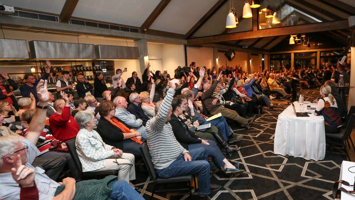 Signs of support: Voters raise their hands when asked at this week's Border Mail Indi election forum whether they supported the McKoy Street-Hume Freeway intersection returning to a 110km/h limit. Picture: JAMES WILTSHIRE