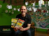 Andy Griffiths with his books in front of a Treehouse story exhibit at the exhibition at Hyphen in Wodonga which runs until May 5. Picture by Tara Trewhella