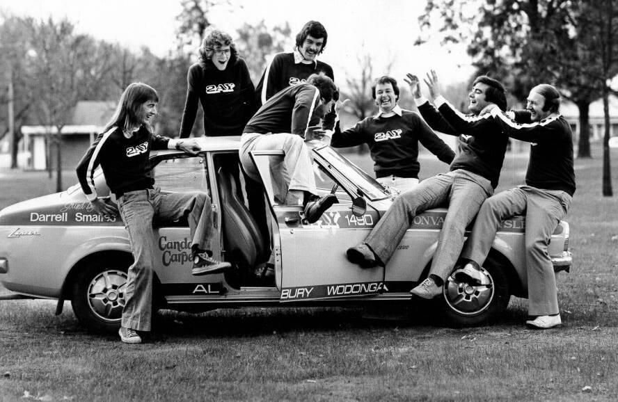 Flashback: The 2AY on-air team from 1975 Peter Watkins, Rob Lee, Andy Walker, Bruce Carter, Max Nordon and Gerry Oliver watch on as breakfast announcer Laurie Henry tries to clamber on to the roof of a promotional car parked at Billson Park in Albury. Henry was one of the most popular early morning hosts in 2AY's history and when he died in 1980 the grief was widespread at his loss.