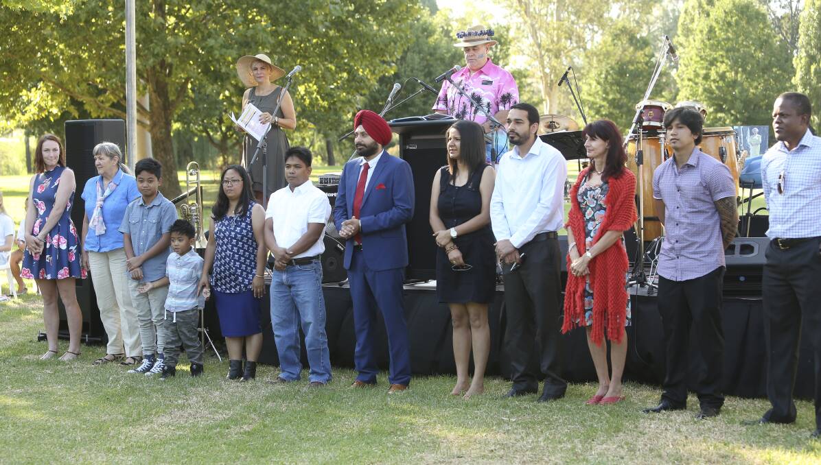 New citizens: Wodonga's latest Aussies, including Harsimrat Singh in suit and tie, in front of mayor Anna Speedie and councillor John Watson.