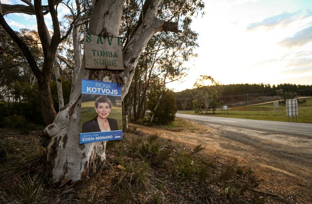 Trunk calls: A poster for Liberal Party candidate Fiona Kotvojs sits underneath an old sign pleading for Tumbarumba Shire to be saved. Picture: JAMES WILTSHIRE