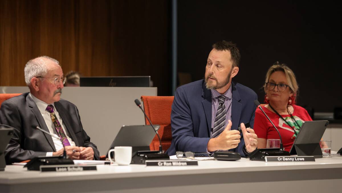 Councillor Danny Lowe speaks about Ron Mildren, before the mayoral vote was held at Wodonga's council meeting on Monday night, as colleague Libby Hall watches on. Picture by James Wiltshire.