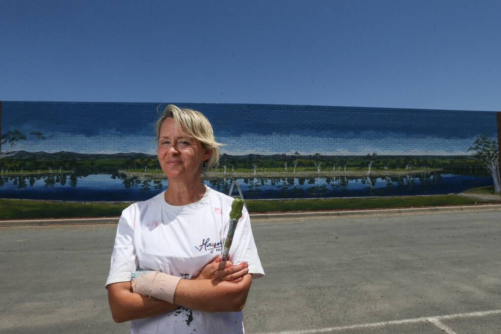 Flashback: Tracy Hancock last year when she completed a mural at Howlong near the town's IGA supermarket. Picture: TARA TREWHELLA
