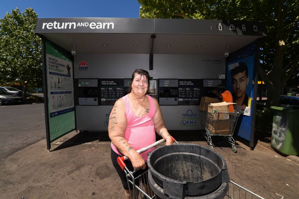 Getting her return: North Albury resident Vicki Thomas with her two large pot plant containers that she brought to the Coles Lavington machine filled with drink containers. Picture: MARK JESSER