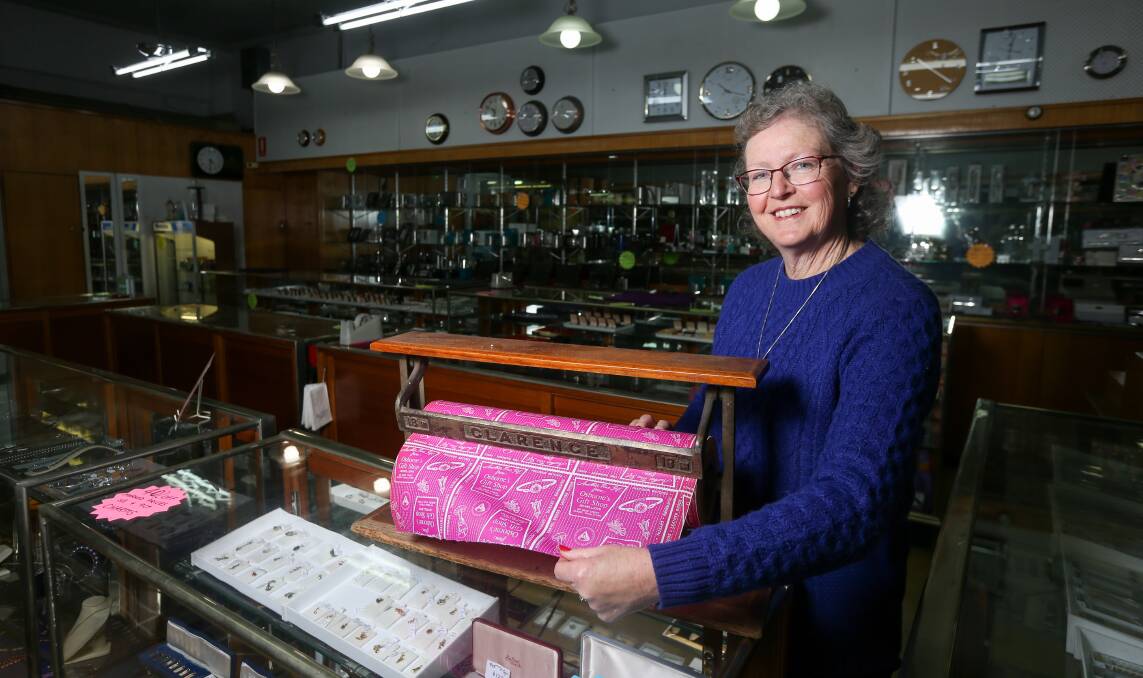 Roll of history: Sandra Kilo has brought out wrapping paper for the closing down sale of Osborne's Gift Shop which dates back decades. It features the store's phone number with only six digits indicating it predates the change to eight-digit numbers in 1997 Picture: TARA TREWHELLA