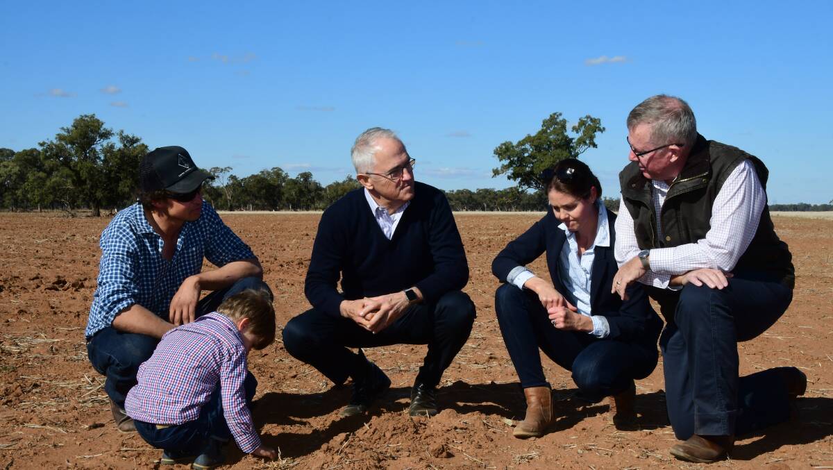 The Big Dry: Farmers Phil and Ahslea Miles and son Jack with Prime Minister Malcolm Turnbull and Parkes MP Mark Coulton during his visit to Trangie in June. Photo: Belinda Soole