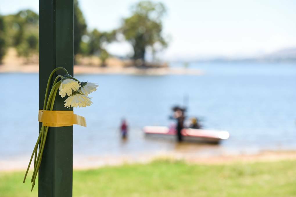TRIBUTE: Flowers left at the scene of the drowing tragedy at Lake Hume. Picture: MARK JESSER