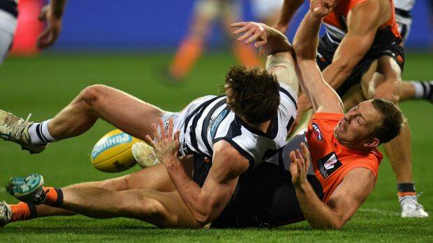 Poor night: Steve Johnson gets tangled up with Jed Bews of the Cats on the ground. Photo: AAP