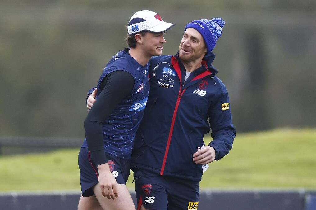YOU'RE IN: Melbourne coach Simon Goodwin (right) tells Daniel Turner of his selection. Picture: MELBOURNE FC
