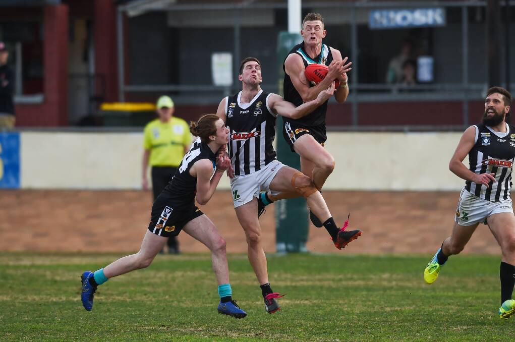Lavington defender Nick Meredith (flying high) will need to be at his best to stop Wangaratta's classy attack.