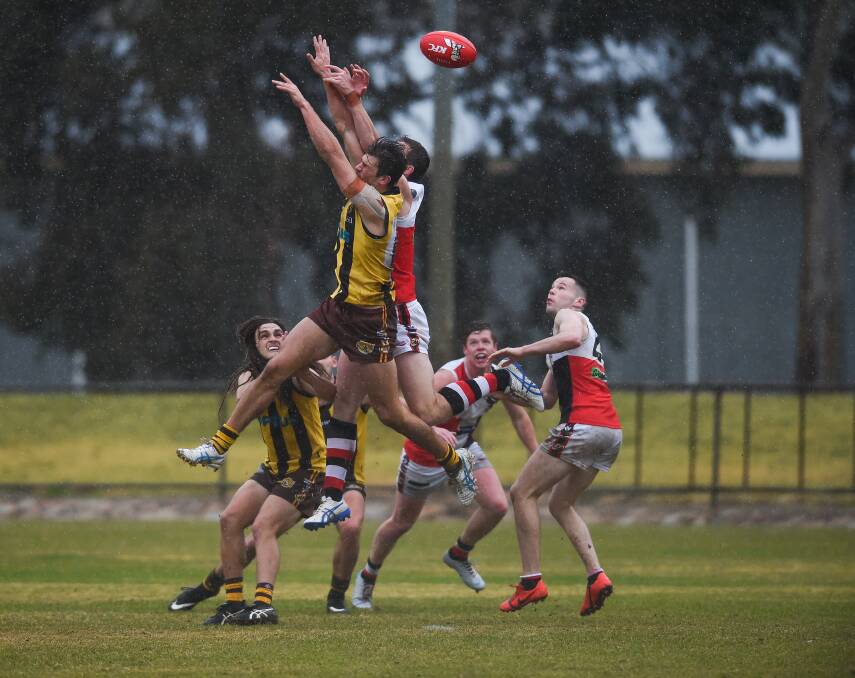 Nathan Cooper jumps for a mark in the wet against Myrtleford last season.