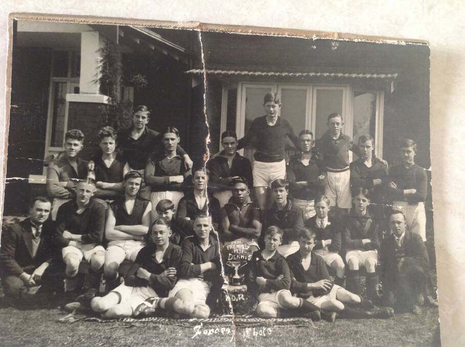 Doug Nicholls (centre) and Norm Smith (tallest in back row) played alongside Claude (taller player sitting next to trophy) and Eddie Turner (seated next to man in suit).