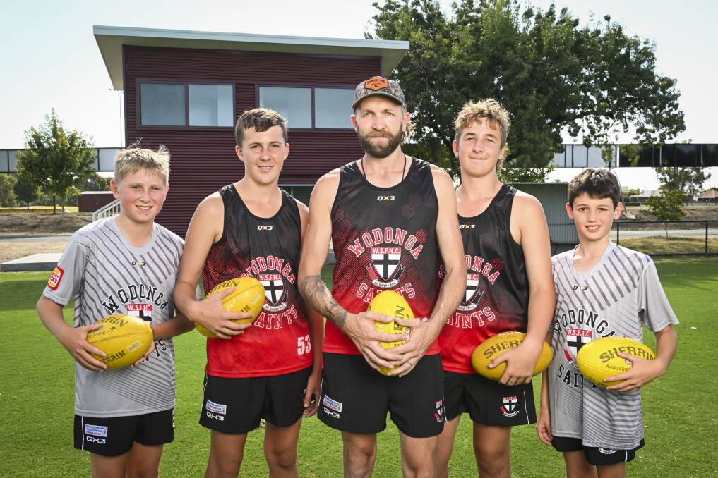 Wodonga Saints are offering free membership and registration for junior footballers with Ryan Sinclair, 12, Seth Chant, 14, coach Brad Chant, Ollie Sims, 14 and Patrick Austin, 12 looking forward to the season. Picture by Mark Jesser